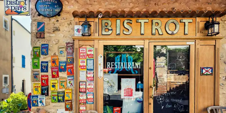 A bistro store front featuring colorful posters.