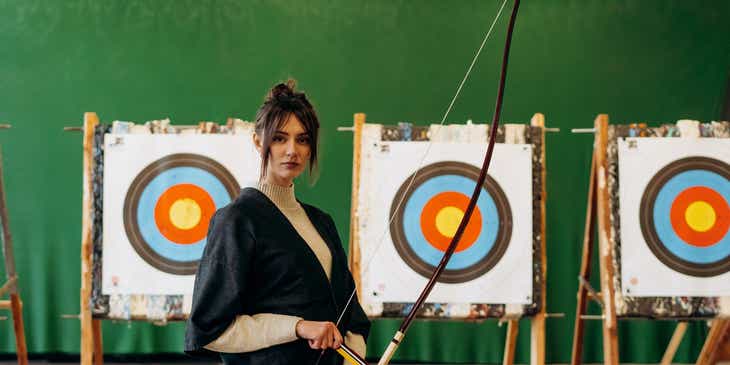 A woman with a bow and arrow.