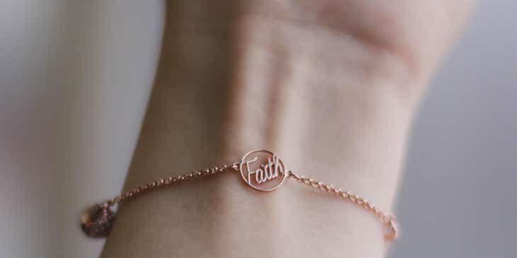 A person wearing a rose gold bracelet