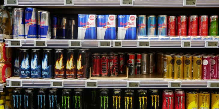 A range of energy drink brands arranged on shelves.