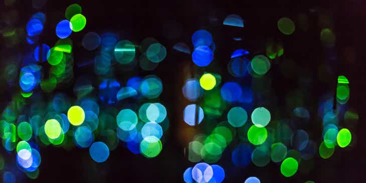 Green and blue glowing dots displayed against a dark background.