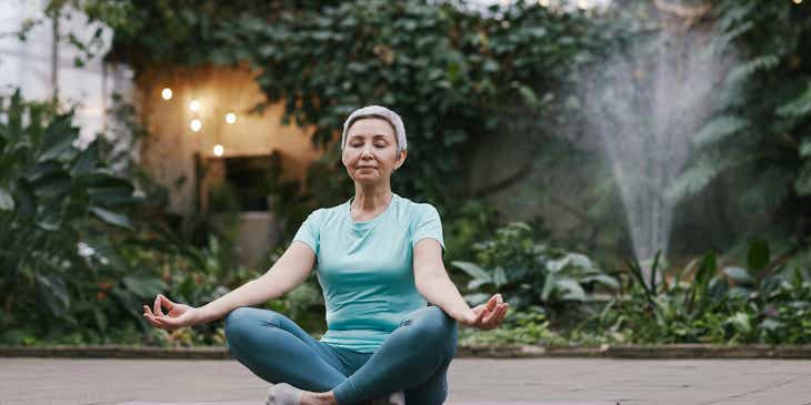 A person practicing health and wellness through yoga in an outdoor area.