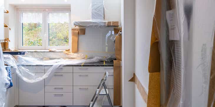 Una cocina protegida con envolturas de plástico durante la renovación de una casa.