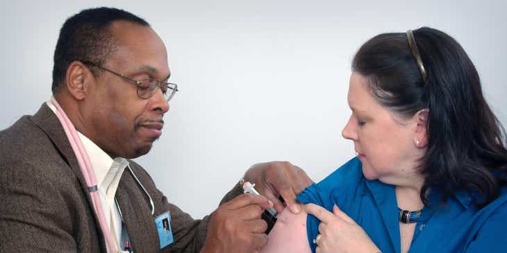 Un praticien de médecine interne administrant une injection.