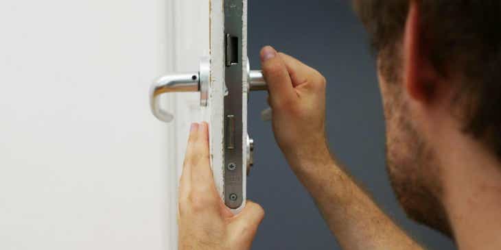 A locksmith fixing a door.