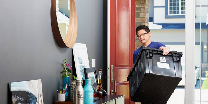 A moving company employee moving a client's belongings to a new home.