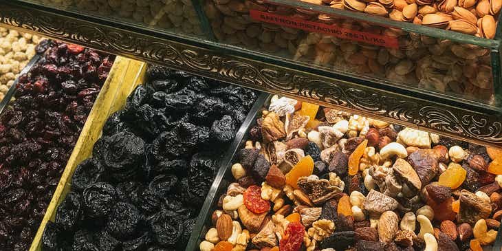 Nuts and dried fruits in a display case at a store.