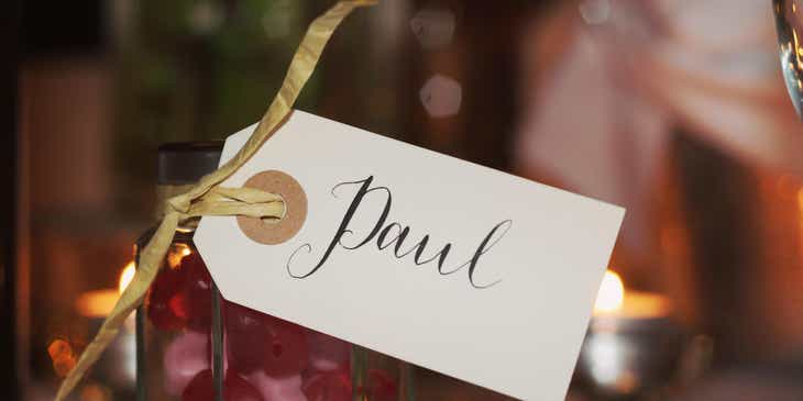 A personalized gift in a glass jar with a tag that says "Paul."