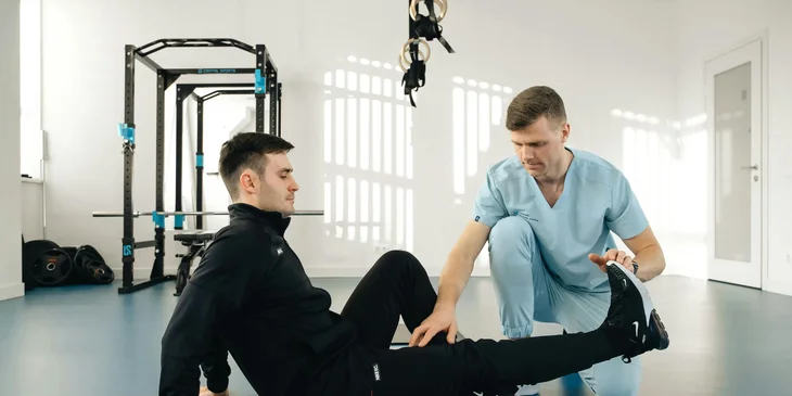 A physical therapist working with a patient.