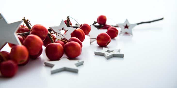 An assortment of red cherries and white stars displayed against a white background.