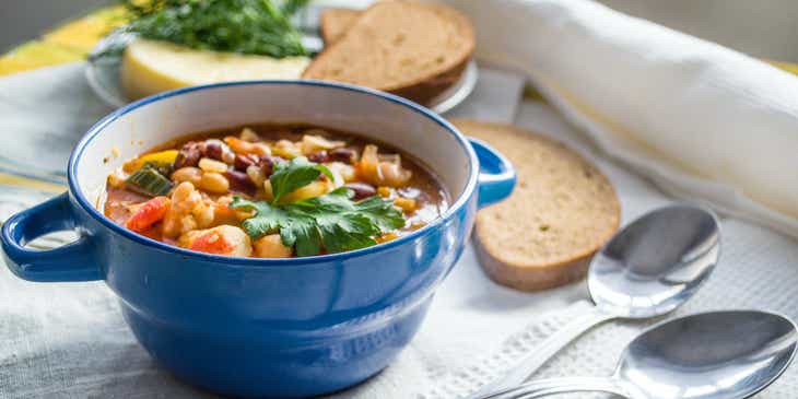 A blue bowl filled with bean soup.